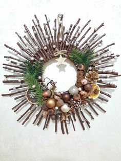 a christmas wreath made out of sticks and ornaments