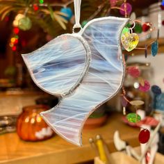 a glass angel ornament hanging from a kitchen counter