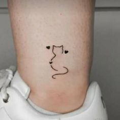 a small cat tattoo on the ankle