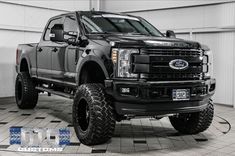 a large black truck parked in a garage