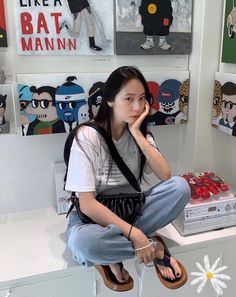 a woman sitting on top of a white counter