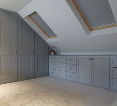 an attic bedroom with lots of storage space