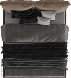 a bed with black and white sheets, pillows and blankets on top of it's headboard