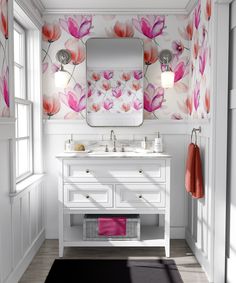 a white bathroom with floral wallpaper and green rug on the floor next to it