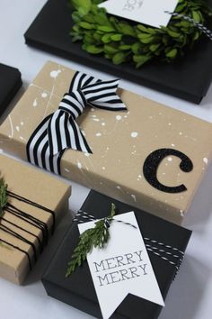 presents wrapped in brown paper with black and white ribbon tied around the letter c on them