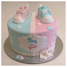 a cake decorated with baby shoes and flowers