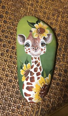 a giraffe with flowers painted on it's head