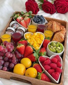 a wooden tray filled with fruit and pastries