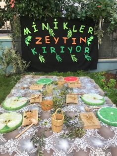 a table topped with lots of food on top of a green and white table cloth