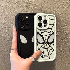 someone is holding up their phone case to show off the spider - man face on it