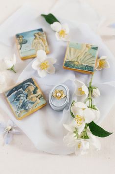 some white flowers and small decorative items on a table