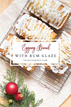 orange bread with rum glaze on a cooling rack next to christmas decorations and greenery