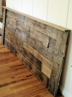 the headboard is made out of wooden planks