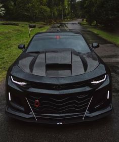 the front end of a black sports car