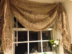 a window covered in burlock and flowers