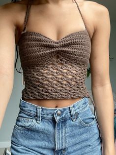 a close up of a person wearing a top with crochet on the bottom