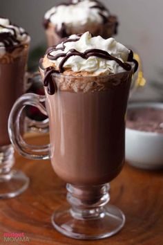 two glasses filled with hot chocolate and whipped cream