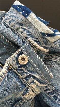 a pair of blue jeans with holes in them