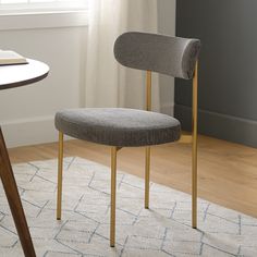 a chair sitting on top of a rug next to a table