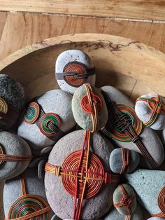 some rocks with different designs on them in a bowl