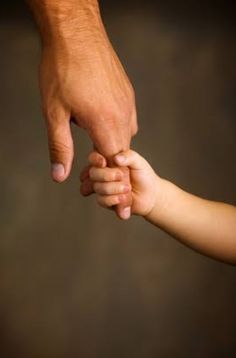 an adult holding the hand of a child's hand