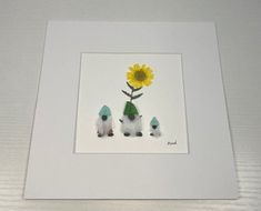 three small white dogs sitting in front of a yellow flower on a white frame with the word love written below it