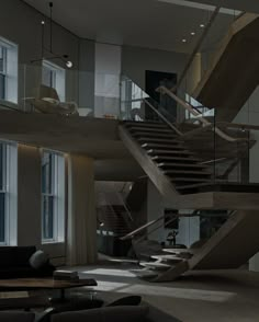 a living room filled with lots of furniture and a stair case next to a window