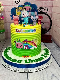 there is a cake that has animals on it and the name cocomelon on top