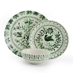 a green and white dinner set on a white background with an image of a bird in the center