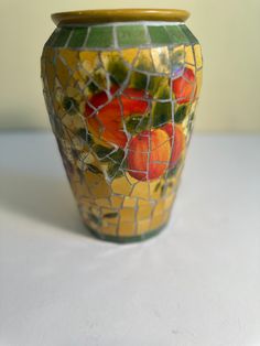 there is a mosaic vase with fruit on it