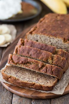 sliced banana bread sitting on top of a wooden cutting board