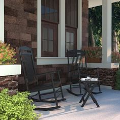 two rocking chairs on the front porch of a house