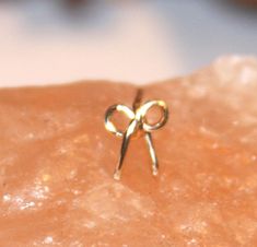 This bow is about 7 mm wide and available in your pick of three post styles: L-shape, 9 mm straight - tragus, or 11 mm straight posts. What fashion enthusiast does not like the ability to make choices? It is my pleasure to offer this cute small nose stud in the following metal picks: 14k gold filled, solid sterling silver, silver filled, and copper. Oh and another choice for my pierced customer. Pick your wire gauge: 22 gauge, 20 gauge, and 18 gauge options. Special Note: Make all your choices f Small Nose Stud, Cute Nose Studs, Small Nose Studs, Cute Nose Rings, Cute Nose, Bow Earring, Tiny Nose Studs, Tiny Nose, Cute Nose Piercings