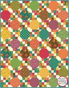 a colorful quilt with circles and dots on it