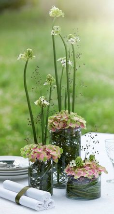 there are flowers in glass vases on the table