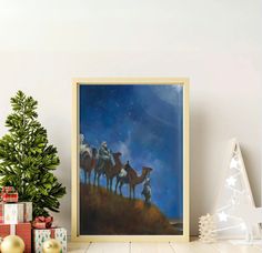 there is a painting on the wall next to christmas presents and a small fir tree