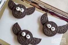 three oreo cookies with googly eyes on them