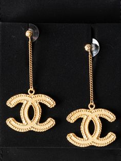 This beautiful pair of Chanel CC earrings are brand new in the box and would make the perfect gift! Plated in matte gold with CC details at post and drop. Includes jewelry pouch and box. Measuring: 2.5 in. L, 1 in. W. Like new: Cc Earrings, Drop Earrings Gold, Dior Shoes, Gold Drop Earrings, Chanel Handbags, Matte Gold, Jewelry Pouch, Designer Bags, Earrings Gold