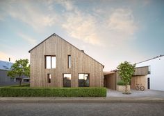 two wooden buildings with windows on the front and side of each building, one is made out of wood