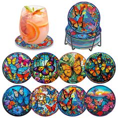 colorful glass plates and coasters with butterflies on them, including a drink in a vase