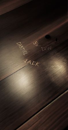 a wooden table with writing on it