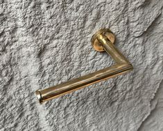 an old brass door handle on a white stucco wall