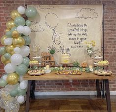 a winnie the pooh birthday party with balloons and desserts on a wooden table