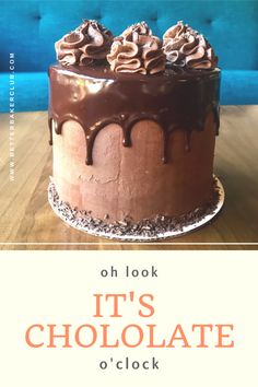 a chocolate cake on a wooden table with the words oh look it's chocolate o'clock