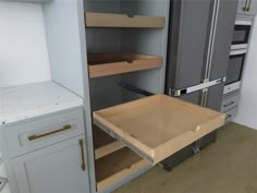 an open drawer in the middle of a kitchen