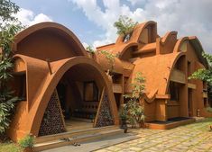 an orange building with arches and windows on the outside