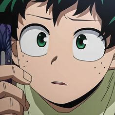 an anime character with green eyes holding a cell phone to his ear and looking at the camera