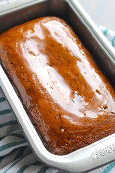 a loaf of cake sitting in a pan on top of a towel