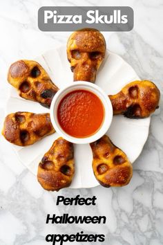 pizza skulls on a white plate with a cup of tomato sauce in the middle and text overlay that reads perfect halloween appetizers