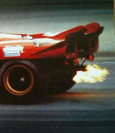 a red race car with flames coming out of it's tires